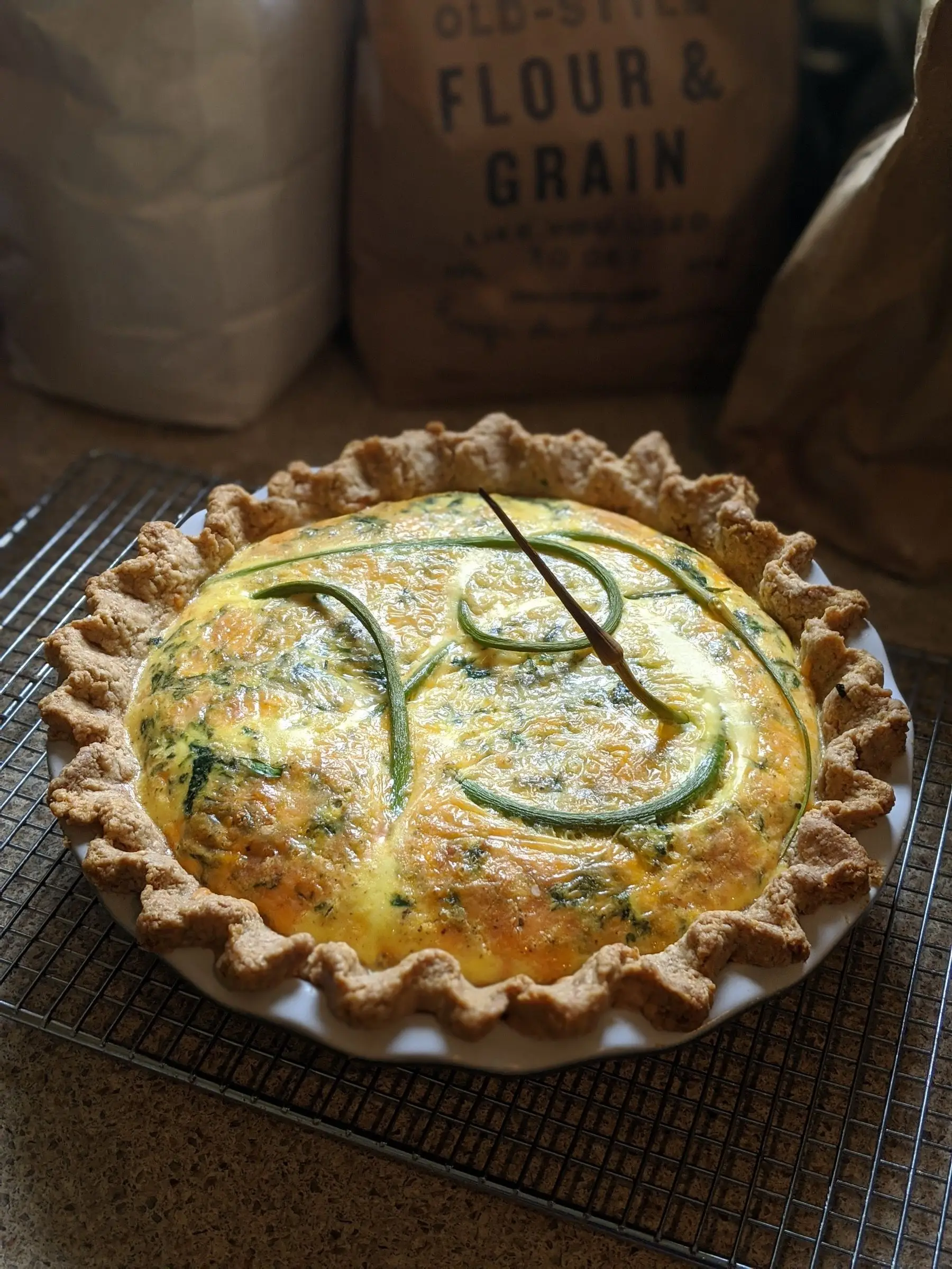 Quiche with garlic scapes and seasonal greens