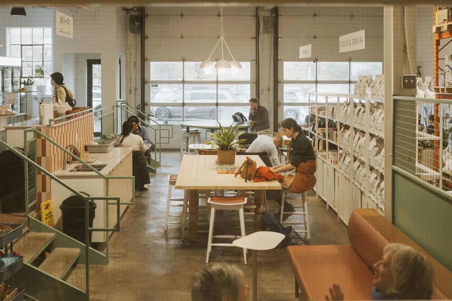 The Almanac café at Little Italy, busy with people at the long table.